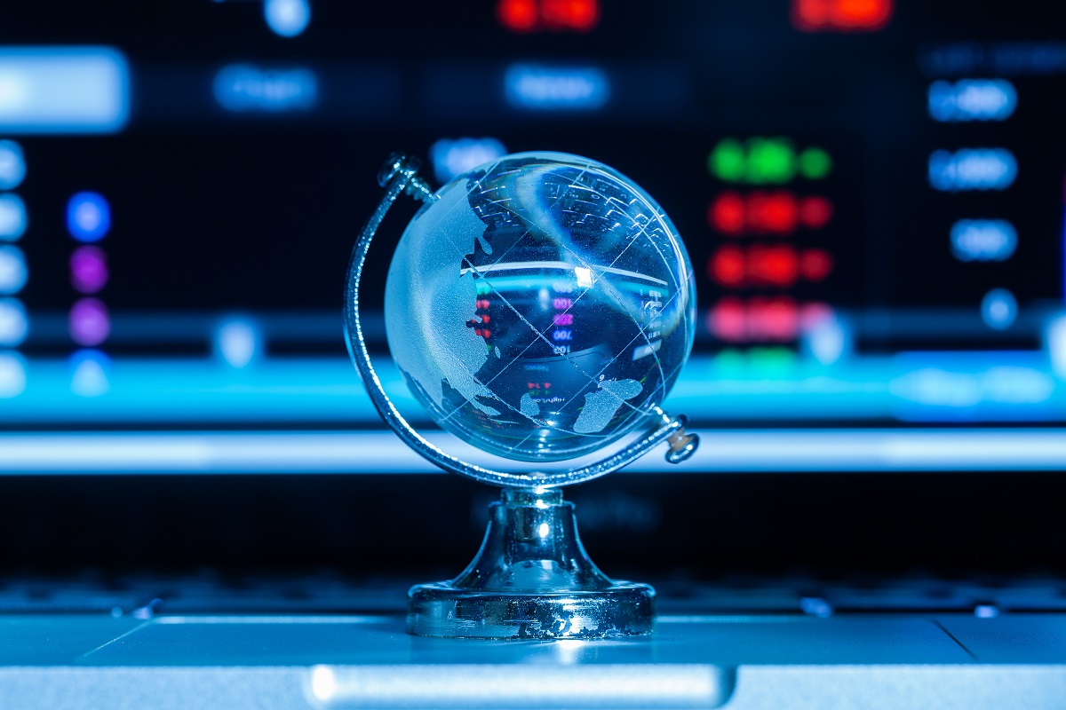 crystal globe in front of a screen displaying numbers