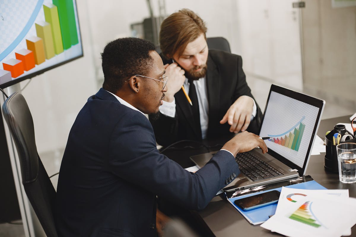 two men looking at a graph on a computer
